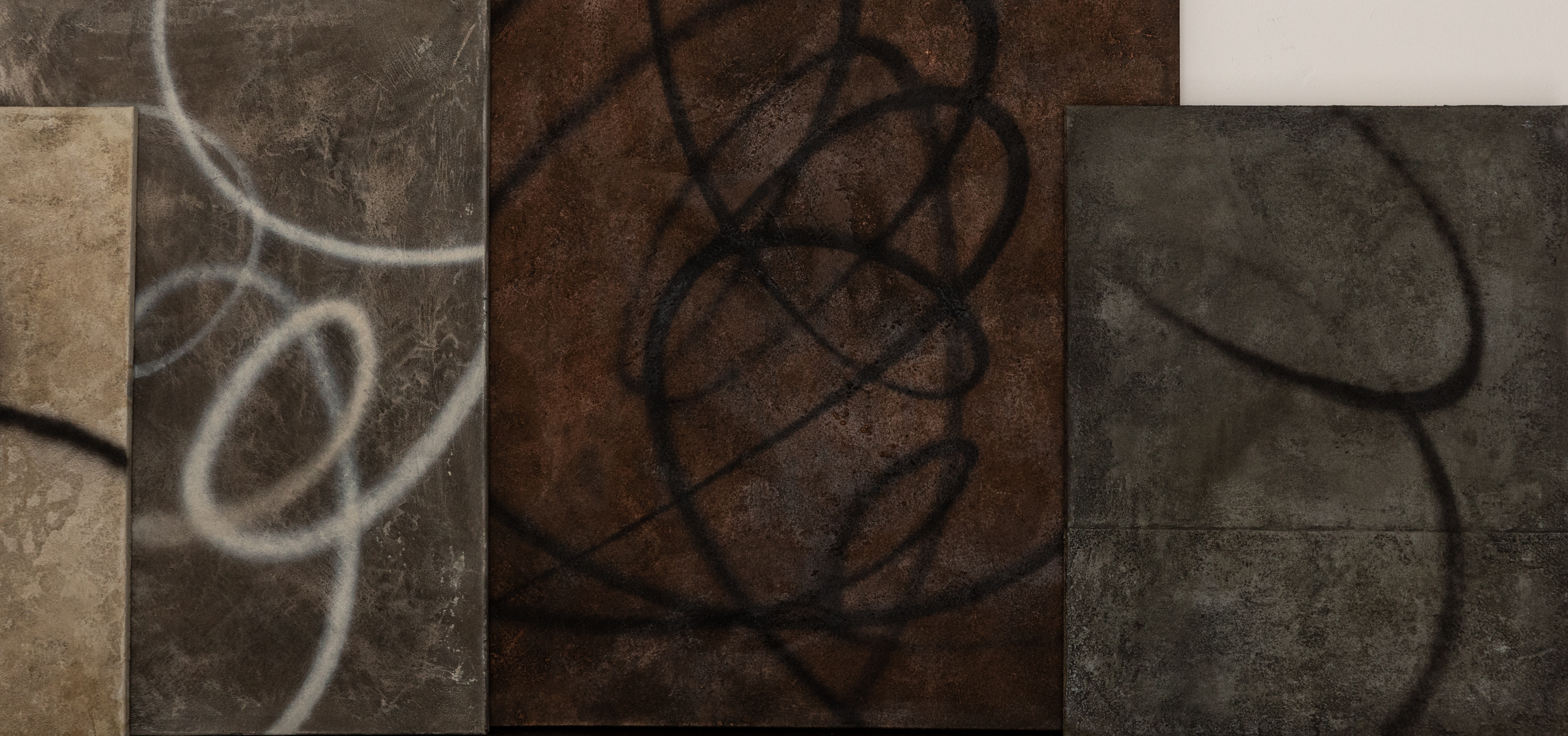 Abstract textured panels with swirling black loops on earthy brown, beige, and dark gray surfaces.