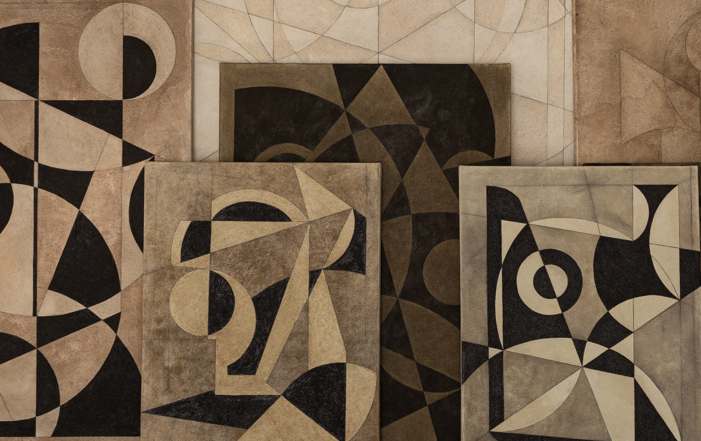 Abstract geometric paintings with bold black, beige, and brown shapes arranged in a layered display.